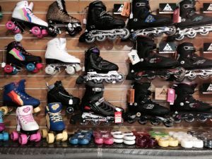 A wall in the store 7 ply that is full of skates, all different colours and sizes.