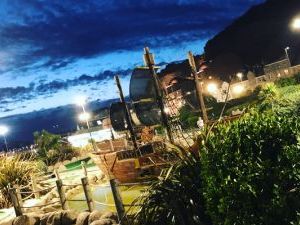 Hastings Adventure golf Pirate boats lit up at night