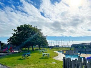 Treasure island outside area with paddling pool and benches on grass